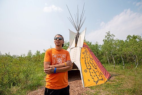 MIKE SUDOMA / Winnipeg Free Press
Artist Jordan Stranger stands with the tipi he created which dipicts the seven sacred teachings at Fort Whyte Friday afternoon. July 30, 2021