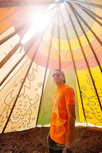 MIKE SUDOMA / Winnipeg Free Press
Artist Jordan Stranger stands inside the tipi he created which dipicts the seven sacred teachings at Fort Whyte Friday afternoon. July 30, 2021