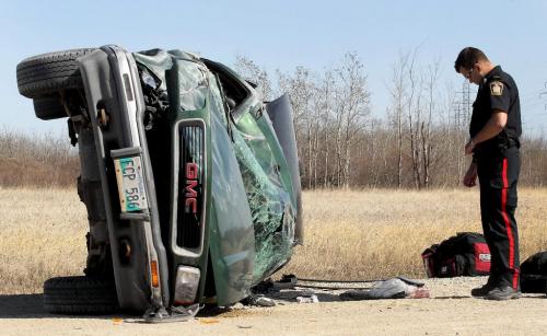 JOE.BRYKSA@FREEPRESS.MB.Ca  Local- -  A Winnipeg Police Services officer investigates rollover mva on Pipeline  and Mollard Road   Friday afternoon that occured around 33)PM - Extent of injuries unknown-Apr 16, 2009- JOE BRYKSA/WINNIPEG FREE PRESS