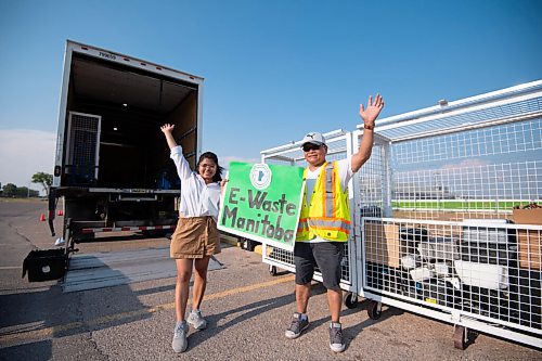 MIKE SUDOMA / Winnipeg Free Press
University student, Aira Villanuvea and her dad Rodrigo Villanuvea hold an E-Waste poster as she hosts an electronic waste drop off event at Tyndall Park Community Centre Friday evening
July 30, 2021