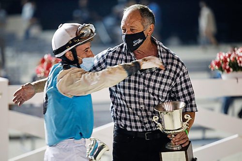 JOHN WOODS / WINNIPEG FREE PRESS
Alexander Marti riding Uncharacteristic (5) and trainer Robert VanOverschot embrace after winning the Manitoba Derby at Assiniboia Downs Monday, August 2, 2021. 

Reporter: ?