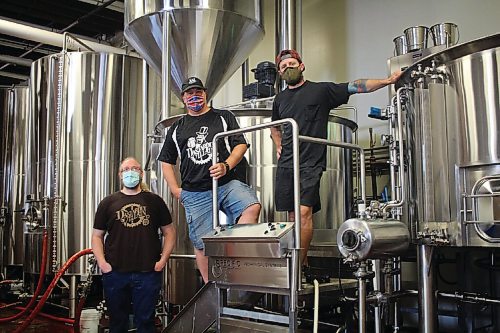 Canstar Community News Jacob Sitter, left, Scott Tackaberry, centre, and Perry Joyal, right, pose at Torque Brewing, where Dastardly Villain Brewing Companys first beer is being made.