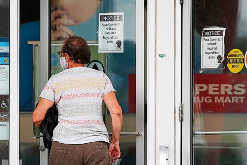 JOHN WOODS / WINNIPEG FREE PRESS
A person walks past mask signage as they enter a Pembina Highway drug store Wednesday, August 4, 2021. Starting Saturday the province has removed mask and other COVID-19 mandates.

Reporter: ?