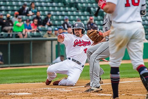 MIKAELA MACKENZIE / WINNIPEG FREE PRESS

 Dakota Conners slides into home base (to get the first home run of the game) as the Goldeyes play Sioux City in Winnipeg on Thursday, Aug. 5, 2021. For Mike Sawatzky story.
Winnipeg Free Press 2021.