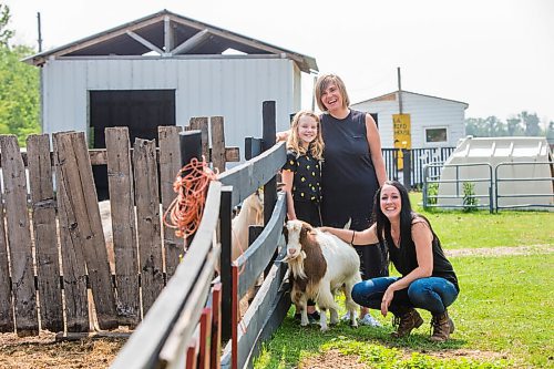 MIKAELA MACKENZIE / WINNIPEG FREE PRESS

Macyn Comeault (left), Carissa Comeault, and Lucy Sloan pose for a portrait with Cindy the goat at Lil' Steps Wellness Farm in St. Malo on Friday, Aug. 6, 2021. For Sabrina story.
Winnipeg Free Press 2021.