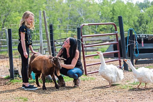 MIKAELA MACKENZIE / WINNIPEG FREE PRESS

Macyn Comeault (left) and Lucy Sloan hang out with the animals at Lil' Steps Wellness Farm in St. Malo on Friday, Aug. 6, 2021. For Sabrina story.
Winnipeg Free Press 2021.