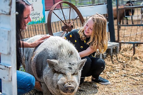 MIKAELA MACKENZIE / WINNIPEG FREE PRESS

Lucy Sloan (left) and Macyn Comeault pet Wilbert the pig at Lil' Steps Wellness Farm in St. Malo on Friday, Aug. 6, 2021. For Sabrina story.
Winnipeg Free Press 2021.