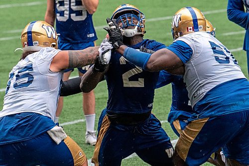 ALEX LUPUL / WINNIPEG FREE PRESS  

Winnipeg Blue Bombers defensive end Jonathan Kongbo (2) attempts to get past offensive linemen Asotui Eli (65) and Jermarcus Hardrick (51) during practice at IG Field on August 9, 2021.

