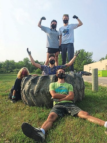 Canstar Community News Mission accomplished: The SOS Summer Team celebrates the removal of a tractor tire from the Seine River (from top): Barb, Paige, Nick, Kennedy, and Isaac.
