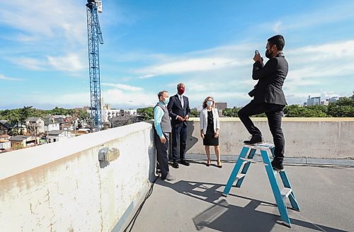 RUTH BONNEVILLE / WINNIPEG FREE PRESS
LOCAL - Housing presser
Ahmed Hussen, Minister of Families, Children and Social Development and Minister Responsible CMHC, along with Kevin Lamoureux, Member of Parliament for Winnipeg North and Caroline DeKeyster
President and CEO, Misericordia Health Centre, hold press announcement on affordable housing on the roof of the Misericordia Health Centre Parkade, Tuesday.
A photo is taken after press conference by an assistant Tuesday.
Aug 10th, 2021