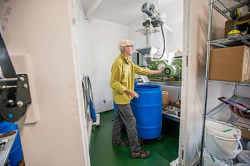 MIKAELA MACKENZIE / WINNIPEG FREE PRESS

David Braun takes a look at the machine before pressing sunflower seeds into oil at Ploughshares Community Farm near Beausejour on Thursday, Aug. 12, 2021. For Jen story.
Winnipeg Free Press 2021.