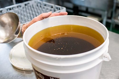 MIKAELA MACKENZIE / WINNIPEG FREE PRESS

David Braun shows how the sunflower oil separates out to become clearer at Ploughshares Community Farm near Beausejour on Thursday, Aug. 12, 2021. For Jen story.
Winnipeg Free Press 2021.