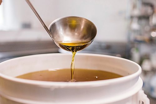 MIKAELA MACKENZIE / WINNIPEG FREE PRESS

David Braun shows off the colour of some of his sunflower oil at Ploughshares Community Farm near Beausejour on Thursday, Aug. 12, 2021. For Jen story.
Winnipeg Free Press 2021.