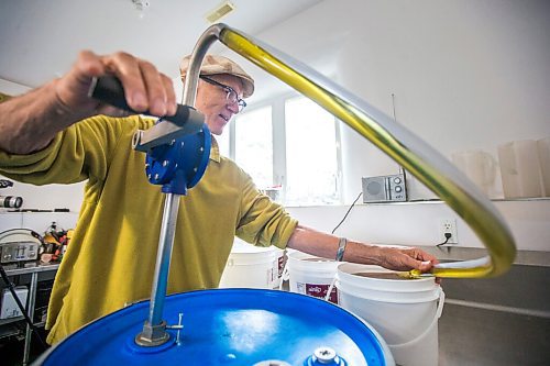 MIKAELA MACKENZIE / WINNIPEG FREE PRESS

David Braun pumps sunflower oil into buckets from the barrel at Ploughshares Community Farm near Beausejour on Thursday, Aug. 12, 2021. For Jen story.
Winnipeg Free Press 2021.