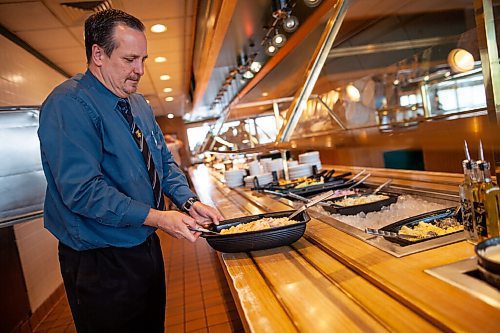 Daniel Crump / Winnipeg Free Press. Robert¤McLellan, general manager at Royal Fork Buffets, puts a fresh salad on the buffet. Pandemic. Pandemic related closures over the past many months meant all but two staff were laid off. Now that the dining room is open, nearly all the employees have returned and businesses is slowly getting back to normal. August 12, 2021.