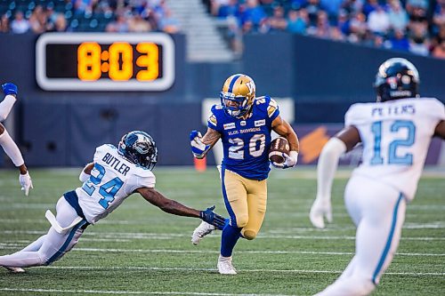 MIKAELA MACKENZIE / WINNIPEG FREE PRESS

Brady Oliveira runs with the ball as Crezdon Butler reaches for him as the Winnipeg Blue Bombers face the Toronto Argonauts at IG Field in Winnipeg on Friday, Aug. 13, 2021. For --- story.
Winnipeg Free Press 2021.