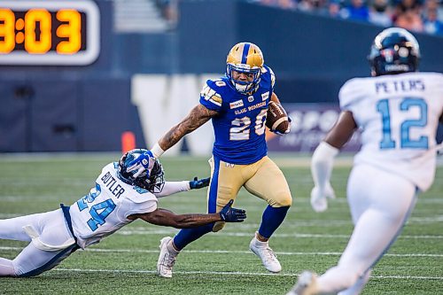 MIKAELA MACKENZIE / WINNIPEG FREE PRESS

Brady Oliveira runs with the ball as Crezdon Butler reaches for him as the Winnipeg Blue Bombers face the Toronto Argonauts at IG Field in Winnipeg on Friday, Aug. 13, 2021. For --- story.
Winnipeg Free Press 2021.