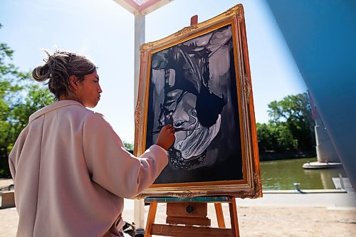 Daniel Crump / Winnipeg Free Press. Nereo Zorro works on a painting titled wings at Buskers Landing at the Forks, Saturday morning. August 12, 2021.