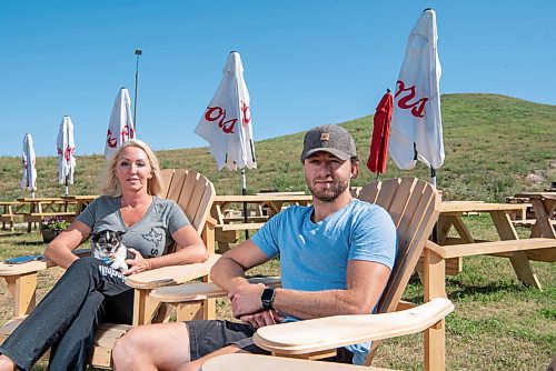 ALEX LUPUL / WINNIPEG FREE PRESS  

From left, Vivianne Julien and Brayden Sosinkalo, co-owners of Springhill Winter Park, are photographed in the ski hill's beer garden on August 13, 2021. 

Reporter: Eva Wasney