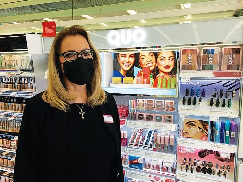 Canstar Community News Jane Baniuk stands in front of Shoppers Drug Marts Quo cosmetic products line at the North Kildonan store where she is cosmetics manager.