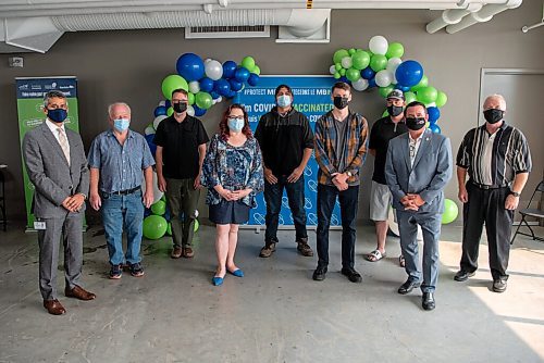 ALEX LUPUL / WINNIPEG FREE PRESS  

Manny Atwal, president and CEO of Manitoba Liquor and Lotteries, and Crown Services Minister Jeff Wharton, pose for a photo with winners of the Vax to Win Lottery at the Leila Avenue vaccination site on August 17, 2021.