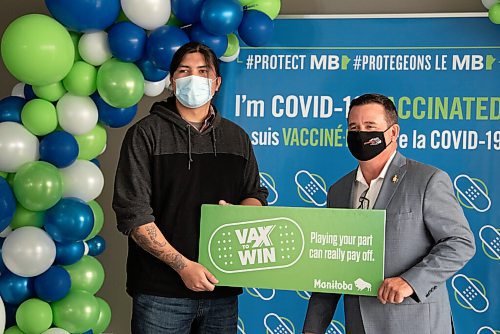 ALEX LUPUL / WINNIPEG FREE PRESS  

Crown Services Minister Jeff Wharton poses for a photo with Bernell Lavallee, one of the Vax to Win Lottery winners, at the Leila Avenue vaccination site on August 17, 2021.