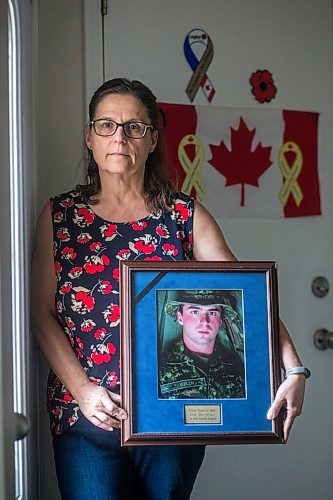 MIKAELA MACKENZIE / WINNIPEG FREE PRESS

Anita Cenerini, mother of Pte. Thomas Welch, poses for a portrait in her home in Winnipeg on Wednesday, Aug. 18, 2021. She has mixed feelings over the fall of Afghanistan to the Taliban. For Erik story.
Winnipeg Free Press 2021.