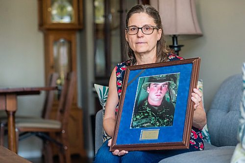 MIKAELA MACKENZIE / WINNIPEG FREE PRESS

Anita Cenerini, mother of Pte. Thomas Welch, poses for a portrait in her home in Winnipeg on Wednesday, Aug. 18, 2021. She has mixed feelings over the fall of Afghanistan to the Taliban. For Erik story.
Winnipeg Free Press 2021.