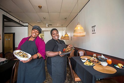 MIKAELA MACKENZIE / WINNIPEG FREE PRESS

Co-owners Deidré Coleman (left) and Patrice Gilman show off two of their signature dishes, the oxtail bowl and jerk wings, at Gladys Caribbean Kitchen in Winnipeg on Thursday, Aug. 19, 2021. For --- story.
Winnipeg Free Press 2021.