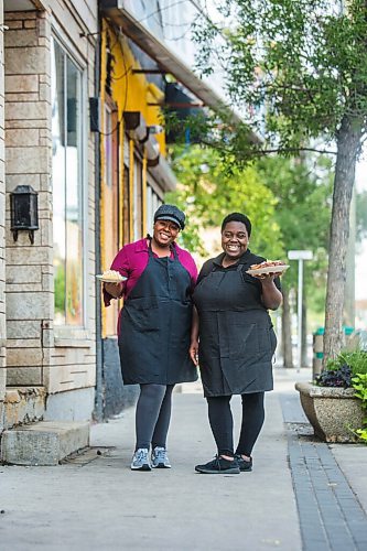 MIKAELA MACKENZIE / WINNIPEG FREE PRESS

Co-owners Deidré Coleman (left) and Patrice Gilman show off two of their signature dishes, ackee and salted cod tacos and jerk chicken, at Gladys Caribbean Kitchen in Winnipeg on Thursday, Aug. 19, 2021. For --- story.
Winnipeg Free Press 2021.