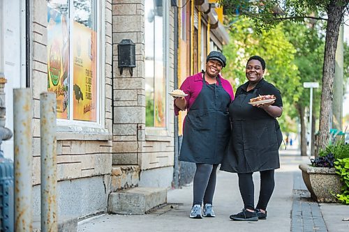 MIKAELA MACKENZIE / WINNIPEG FREE PRESS

Co-owners Deidré Coleman (left) and Patrice Gilman show off two of their signature dishes, ackee and salted cod tacos and jerk chicken, at Gladys Caribbean Kitchen in Winnipeg on Thursday, Aug. 19, 2021. For --- story.
Winnipeg Free Press 2021.