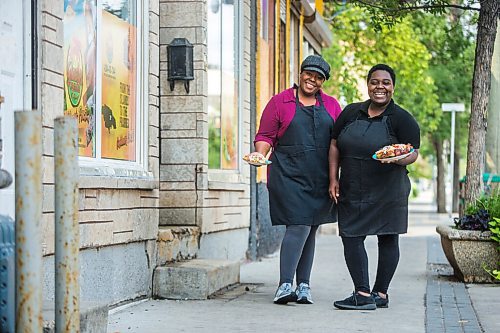 MIKAELA MACKENZIE / WINNIPEG FREE PRESS

Co-owners Deidré Coleman (left) and Patrice Gilman show off two of their signature dishes, ackee and salted cod tacos and jerk chicken, at Gladys Caribbean Kitchen in Winnipeg on Thursday, Aug. 19, 2021. For --- story.
Winnipeg Free Press 2021.