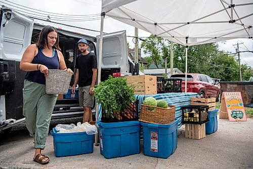 ALEX LUPUL / WINNIPEG FREE PRESS  

Janelle Wride, Delivery Coordinator for Fireweed Food Co-op, and Paul Dyck, a volunteer, pose for a photo with their vegetable stand as part of Fireweed's Veggie Van program on August 19, 2021. The program offers affordable local produce to those in lower income neighbourhoods.