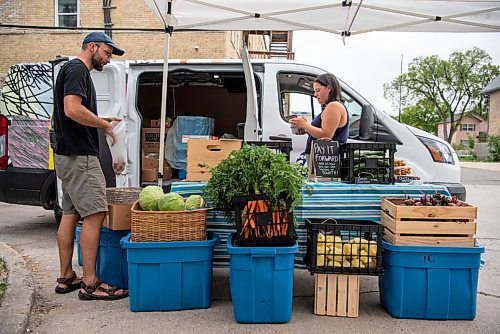 ALEX LUPUL / WINNIPEG FREE PRESS  

Janelle Wride, Delivery Coordinator for Fireweed Food Co-op, and Paul Dyck, a volunteer, pose for a photo with their vegetable stand as part of Fireweed's Veggie Van program on August 19, 2021. The program offers affordable local produce to those in lower income neighbourhoods.