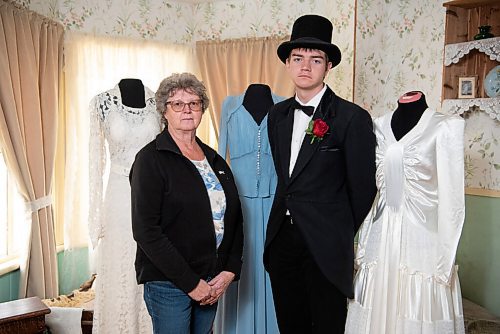 ALEX LUPUL / WINNIPEG FREE PRESS  

Diana Vodden, Co-Chair of The Nellie McClung Heritage Site, and Tyler Johnson, an interpretive guide, are photographed next to dresses which are part of the Great Depression & War Collection at The Nellie McClung Heritage Site in Manitou on August, 23, 2021. The I DO Exhibit celebrates the 125th wedding anniversary of Wes and Nellie McClung. Nellie McClung was a pioneer teacher, author, suffragist, social reformer, lecturer and legislator