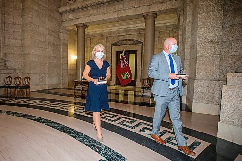 MIKAELA MACKENZIE / WINNIPEG FREE PRESS

Chief provincial nursing officer Lanette Siragusa (left) and chief provincial public health officer Dr. Brent Roussin  leave with their bison statuettes after the Order of the Buffalo Hunt ceremony at the Manitoba Legislative Building in Winnipeg on Tuesday, Aug. 24, 2021. For --- story.
Winnipeg Free Press 2021.