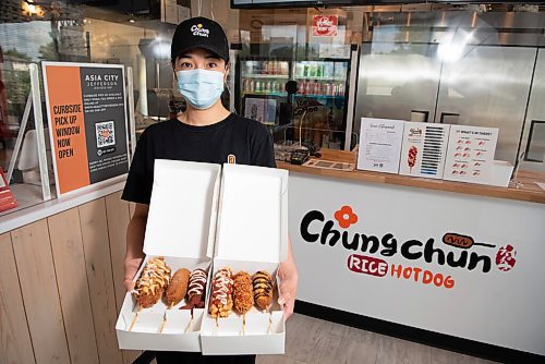 ALEX LUPUL / WINNIPEG FREE PRESS  

Jane Khau, owner of Chung Chun Rice Dog's Jefferson Avenue location in Winnipeg, holds a selection of their Korean-style hotdogs on August, 25, 2021.
