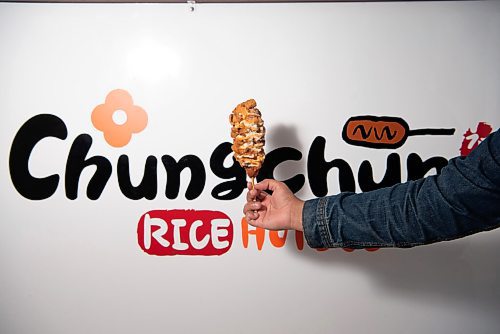 ALEX LUPUL / WINNIPEG FREE PRESS  

A chicken topping hotdog is photographed in front of signage at Chung Chun Rice Dog's Jefferson Avenue location in Winnipeg on August, 25, 2021.