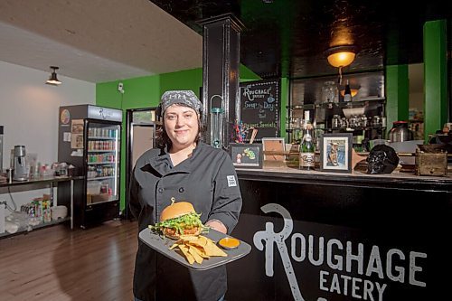 MIKE SUDOMA / Winnipeg Free Press
Jessie Hodel, Owner of Roughage Eatery, holds up the Hunny Spicy Chicken Burger, Roughage Eaterys entry in this years Le Burger Week, Thursday afternoon
August 26, 2021