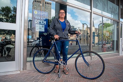 ALEX LUPUL / WINNIPEG FREE PRESS  

Tammy Skrabek, curator of the Winnipeg Police Museum & Historical Society, is photographed with a police bike outside of the museum in Winnipeg on August, 26, 2021.