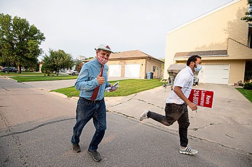 MIKE SUDOMA / Winnipeg Free Press
Kevin Lamoureux  and assistant Carl Foja hustle from house to house while campaigning through Tyndall Park Thursday evening 
August 26, 2021