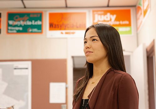 MIKE SUDOMA / Winnipeg Free Press
NDP MLA for Winnipeg North, Melissa Chung-Mowat walks in front of a wall displaying signs of past MLAs Friday
August 27, 2021