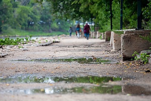 Daniel Crump / Winnipeg Free Press. Puddles line the river walk between the legislature and the Forks Saturday morning following rain fall overnight. August 28, 2021.