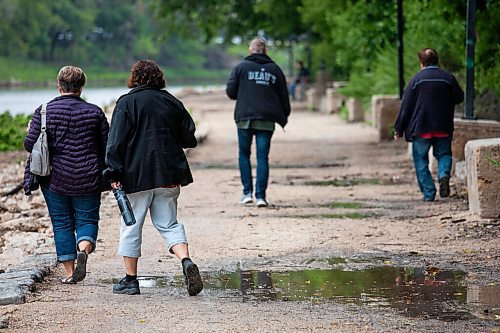 Daniel Crump / Winnipeg Free Press. Puddles line the river walk between the legislature and the Forks Saturday morning following rain fall overnight. August 28, 2021.