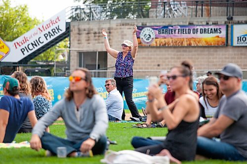 Daniel Crump / Winnipeg Free Press. Cindy McKay dances to the live music at the Unite Manitoba 150 celebrations at Shaw Park in downtown Winnipeg. August 28, 2021.