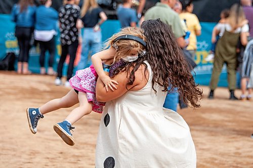 Daniel Crump / Winnipeg Free Press. Elizabeth Proskurnik dances with her 3-year-old daughter, Rielle Prokurnik, at the Unite Manitoba 150 celebrations at Shaw Park in downtown Winnipeg. August 28, 2021.