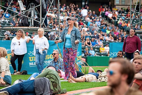 Daniel Crump / Winnipeg Free Press. Michelle Miller dances while William Prince performs at the Unite Manitoba 150 celebrations at Shaw Park in downtown Winnipeg. August 28, 2021.