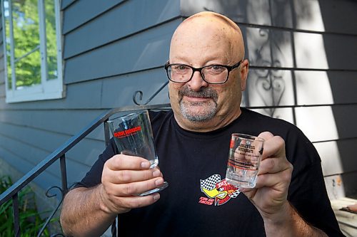 MIKE DEAL / WINNIPEG FREE PRESS
Craig Kraft, 61, with a River Rouge glass and a small Paddlewheel mug also has a modest collection of items associated with Winnipeg's riverboat era; postcards, buttons, boarding passes etc. from the various ships that used to parade up and down the Red, the River Rouge, Paddlewheel, Paddlewheel Princess etc.
See David Sanderson story
210831 - Tuesday, August 31, 2021.