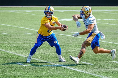 MIKE DEAL / WINNIPEG FREE PRESS
Winnipeg Blue Bombers quarterback Zach Collaros (8) hands the ball to Brady Oliveira (20) during practice at IG Field Wednesday afternoon.
210901 - Wednesday, September 01, 2021.