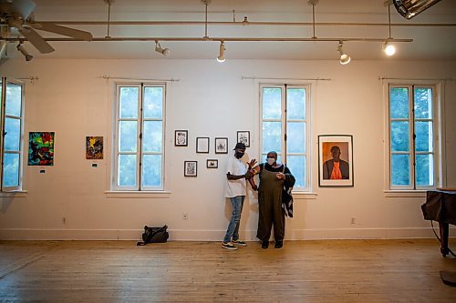 Daniel Crump / Winnipeg Free Press.  Raising New Voices mentees, Pajack Obeing and Jibu Kamabu, chat in gallery at the St. Norbert Art Centre. Nine mentees from the Raising New Voices mentorship program showed work at Gerryfest 2021. September 2, 2021.